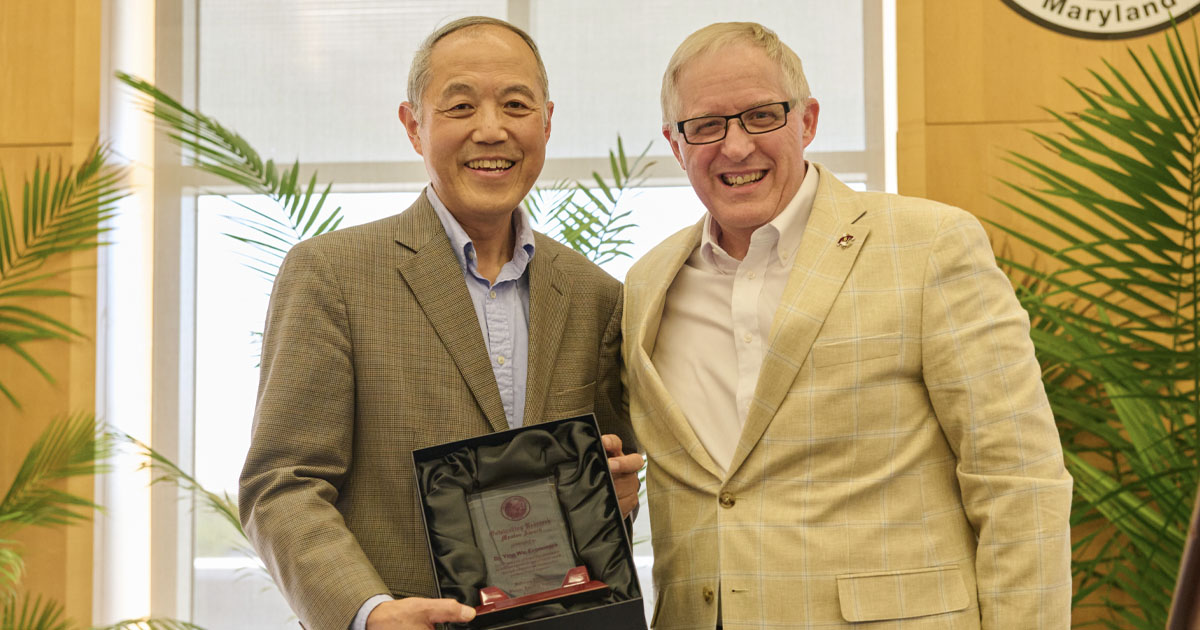 Dr. Ying Wu, left, receives the 2026 SU Outstanding Research Mentor Award from Dr. Clifton Griffin, dean of graduate studies and research